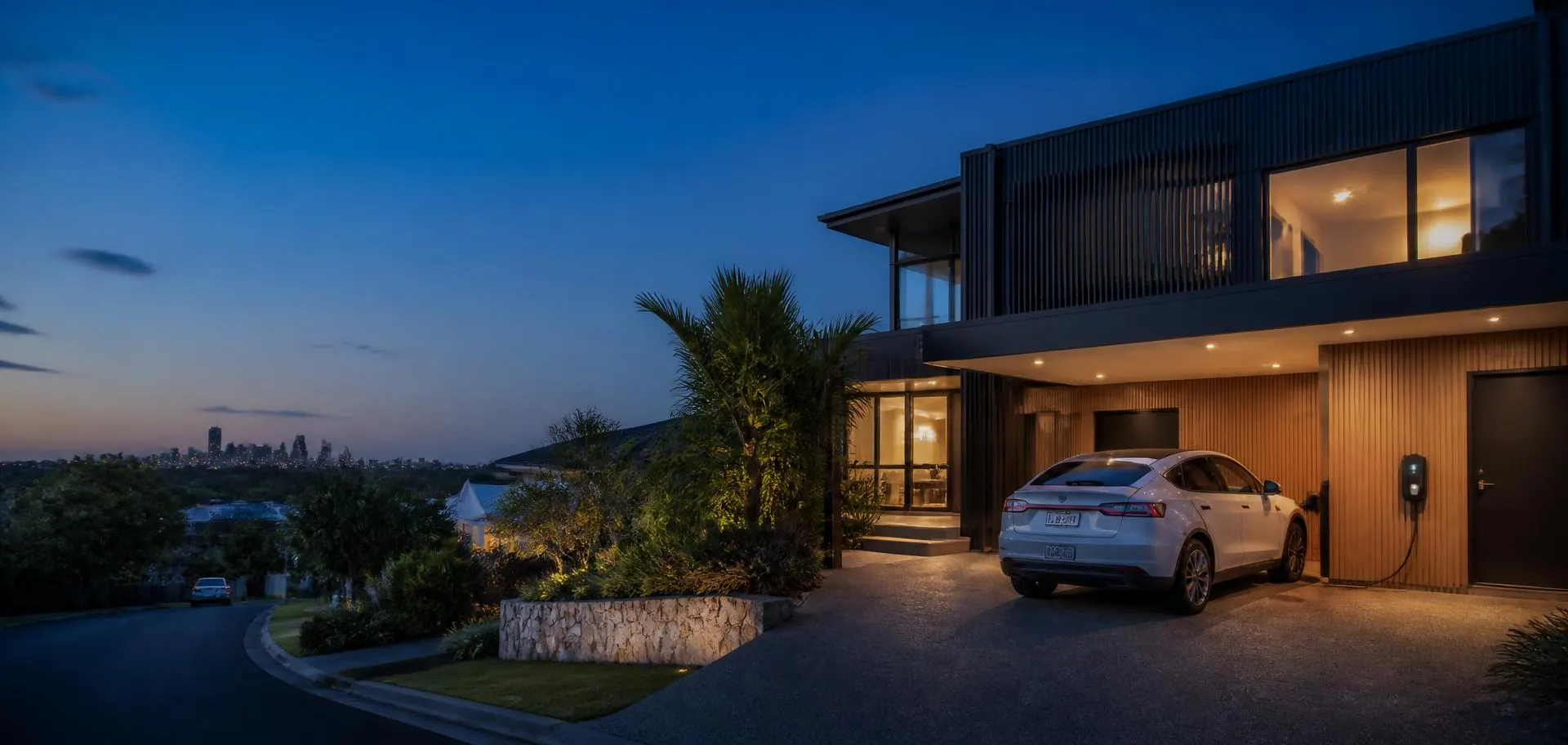 Electric car charging in the driveway of a contemporary Brisbane home at dusk